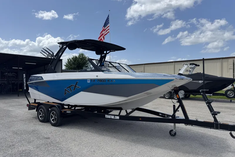 The Image of 2021 ATX Surf Boats 22 Type-S on trailer, parked outdoors under a blue sky. - 1
