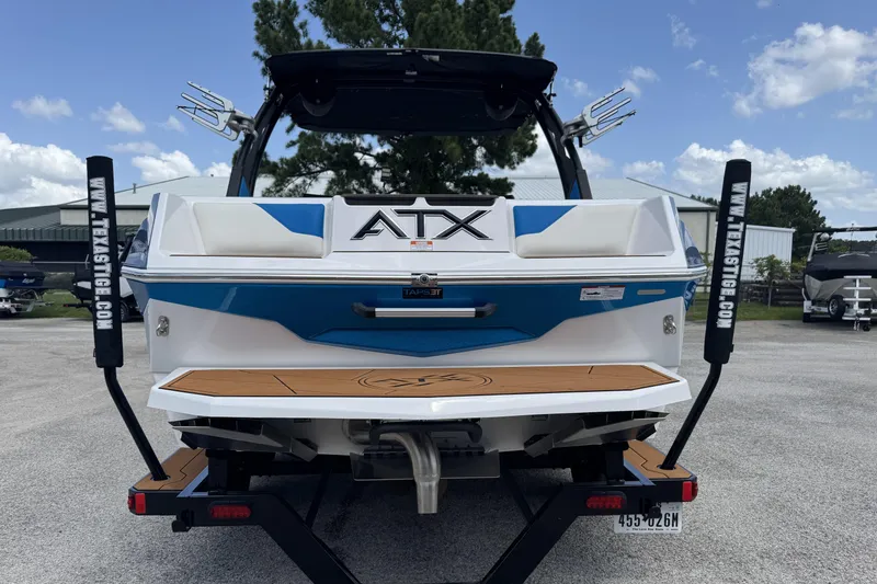 Slide: The Image of 2021 ATX Surf Boats 22 Type-S, rear view, on trailer, blue and white design. - 3