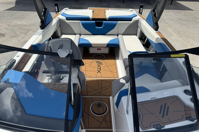 Slide: The Image of 2021 ATX Surf Boats 22 Type-S interior with blue and white seating, open cockpit view. - 9