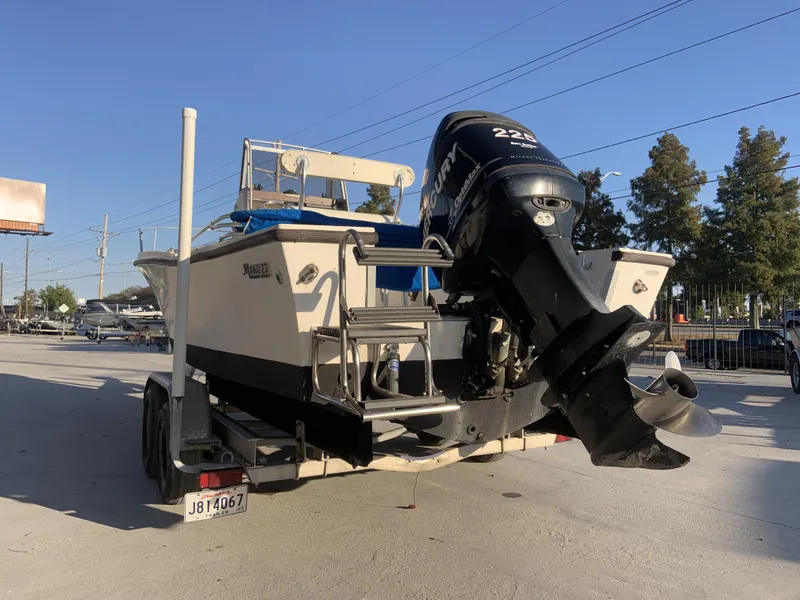 Slide: The Image of 1988 Mako 231 Center Console boat on trailer with Mercury outboard motor. - 9