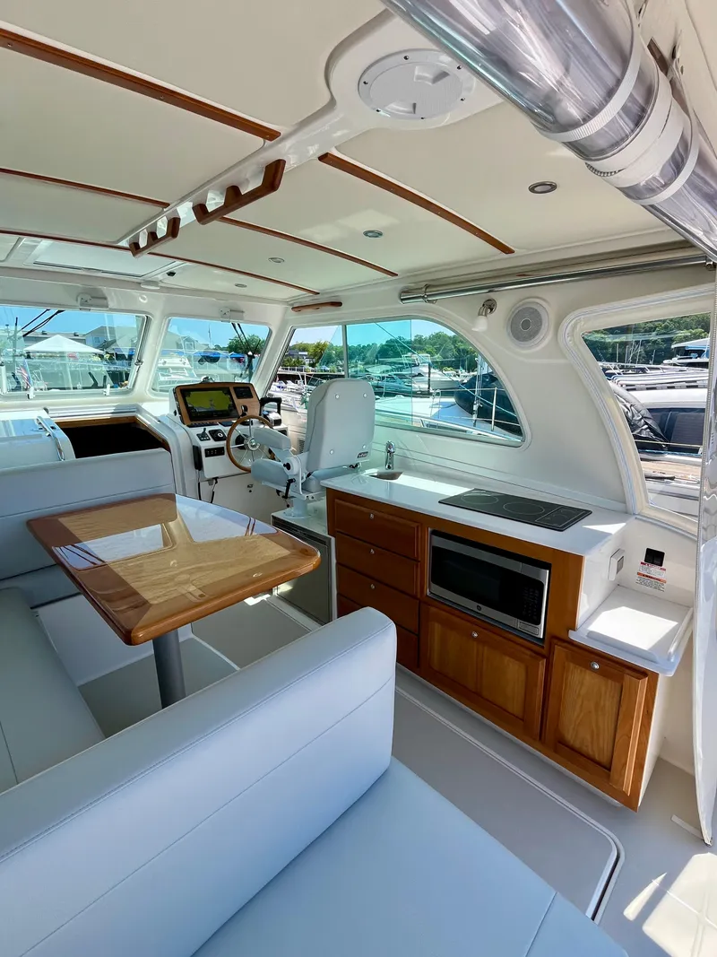 Slide: The Image of Interior of 2023 Back Cove 34O yacht with modern seating and kitchen amenities. - 14