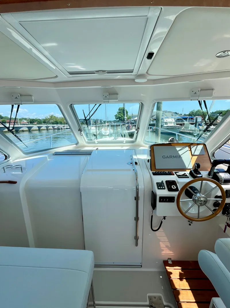 Slide: The Image of Interior view of 2023 Back Cove 34O boat cockpit with Garmin navigation system. - 16