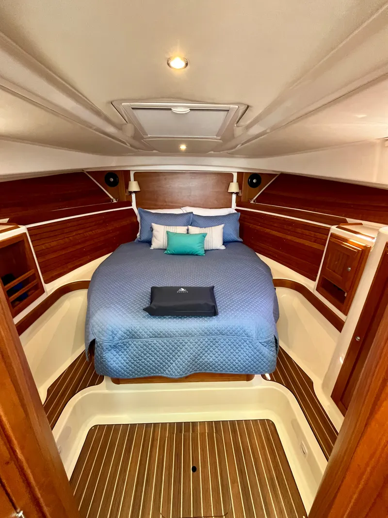 Slide: The Image of Luxurious cabin interior of 2023 Back Cove 34O with elegant wood finish and cozy bedding. - 21