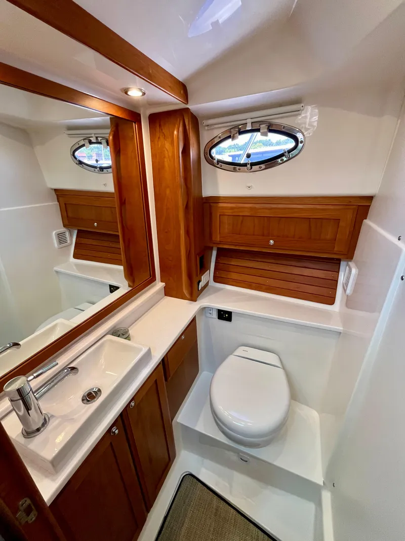 Slide: The Image of Luxurious bathroom in 2023 Back Cove 34O yacht, featuring wood accents and modern fixtures. - 25