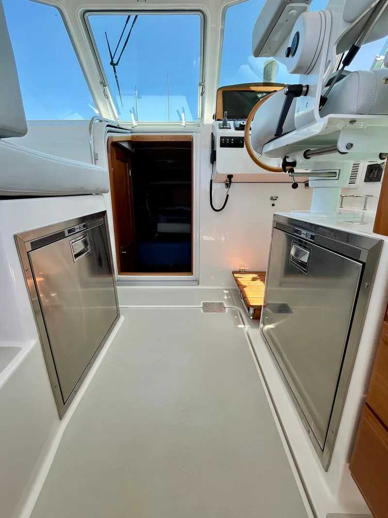 Slide: The Image of 2023 Back Cove 34O interior with modern helm and stainless steel appliances. - 27