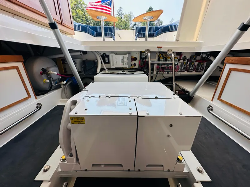 Slide: The Image of Engine compartment of 2023 Back Cove 34O boat, showcasing mechanical components and storage. - 30
