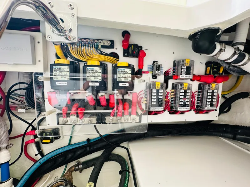 Slide: The Image of Electrical panel of 2023 Back Cove 34O boat, featuring wiring and circuit breakers. - 33