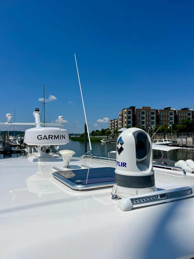 Slide: The Image of 2023 Back Cove 34O yacht with Garmin and FLIR equipment, docked near modern buildings. - 39