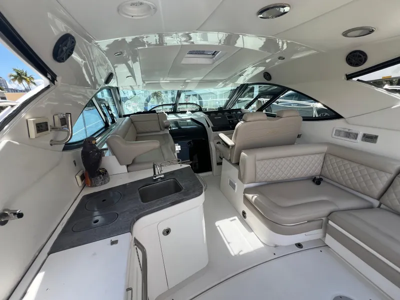 Slide: The Image of Luxurious interior of 2013 Sea Ray 410 Sundancer yacht with seating and kitchenette. - 11