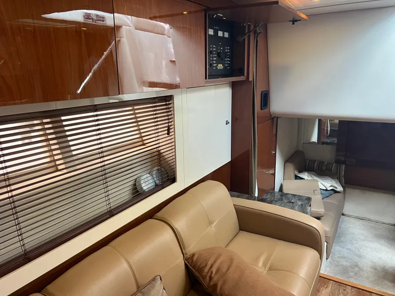 Slide: The Image of Interior of 2013 Sea Ray 410 Sundancer yacht with leather seating and wooden cabinetry. - 21