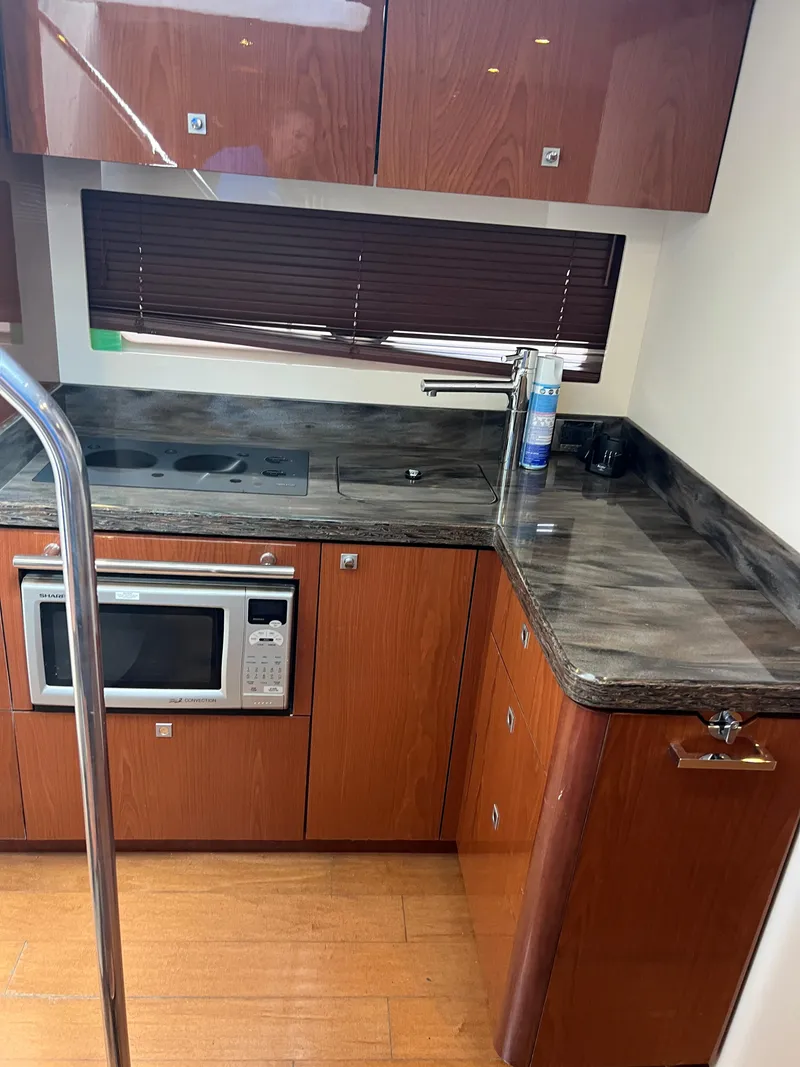 Slide: The Image of Luxurious kitchen area in 2013 Sea Ray 410 Sundancer yacht with modern appliances. - 24