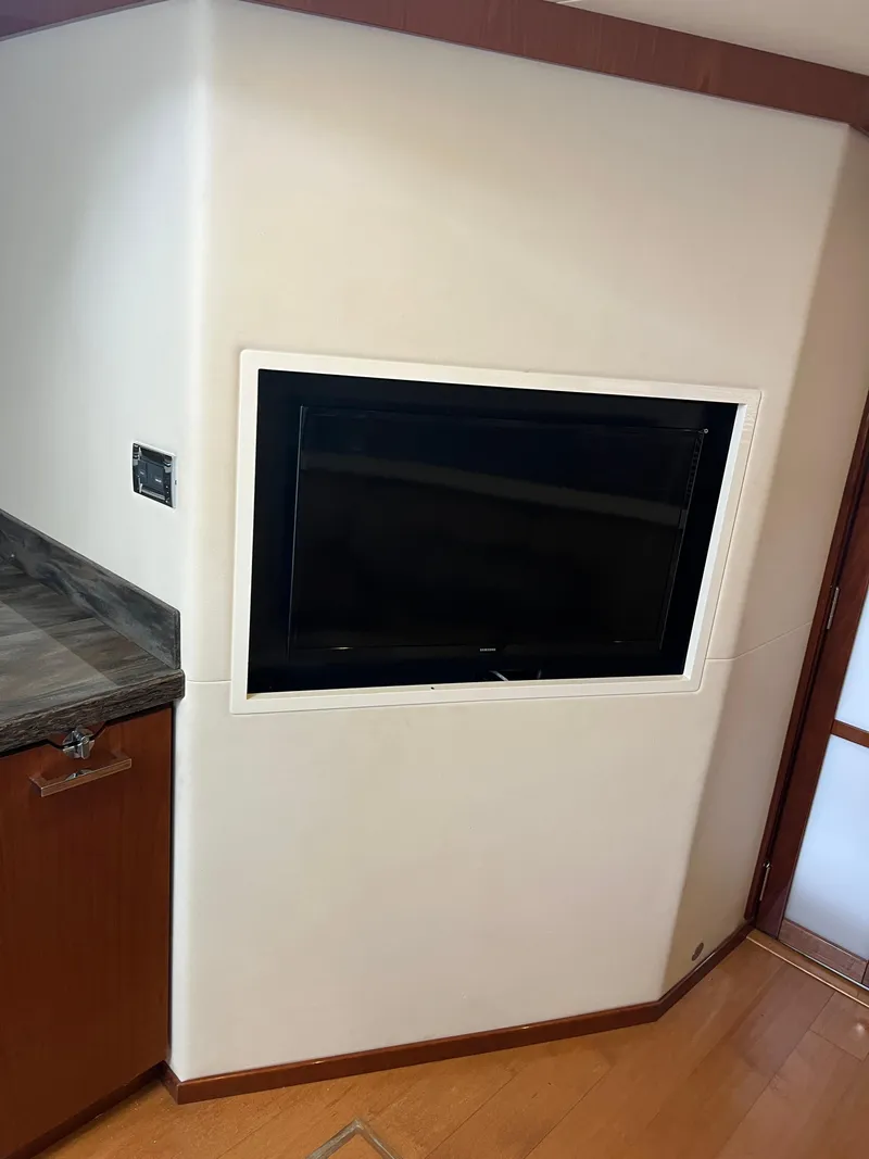 Slide: The Image of Built-in TV on Sea Ray 410 Sundancer yacht, 2013 model, with wooden cabinetry. - 25