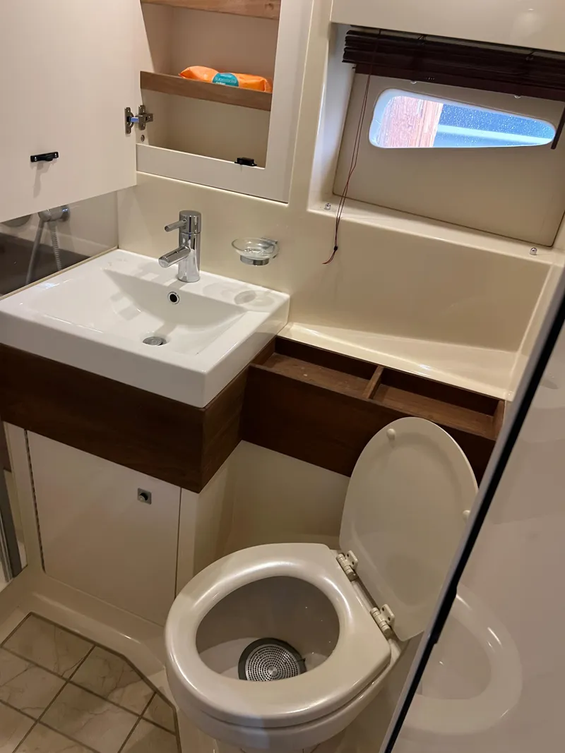 Slide: The Image of Bathroom interior of 2013 Sea Ray 410 Sundancer yacht, featuring sink and toilet. - 28