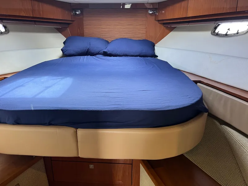 Slide: The Image of Luxurious cabin interior of 2013 Sea Ray 410 Sundancer with blue bedding. - 29
