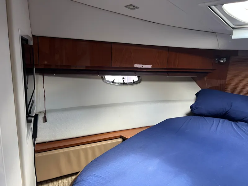 Slide: The Image of Interior cabin of 2013 Sea Ray 410 Sundancer yacht with bed and wooden cabinets. - 30