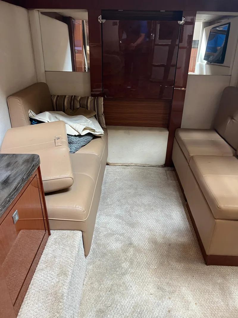 Slide: The Image of Interior of 2013 Sea Ray 410 Sundancer with beige seating and carpet. - 32