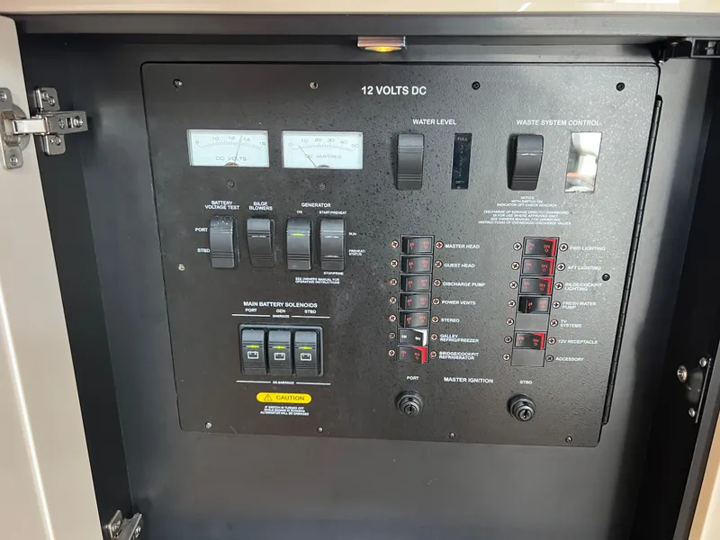 Slide: The Image of Control panel of a 2013 Sea Ray 410 Sundancer boat, featuring switches and gauges. - 33