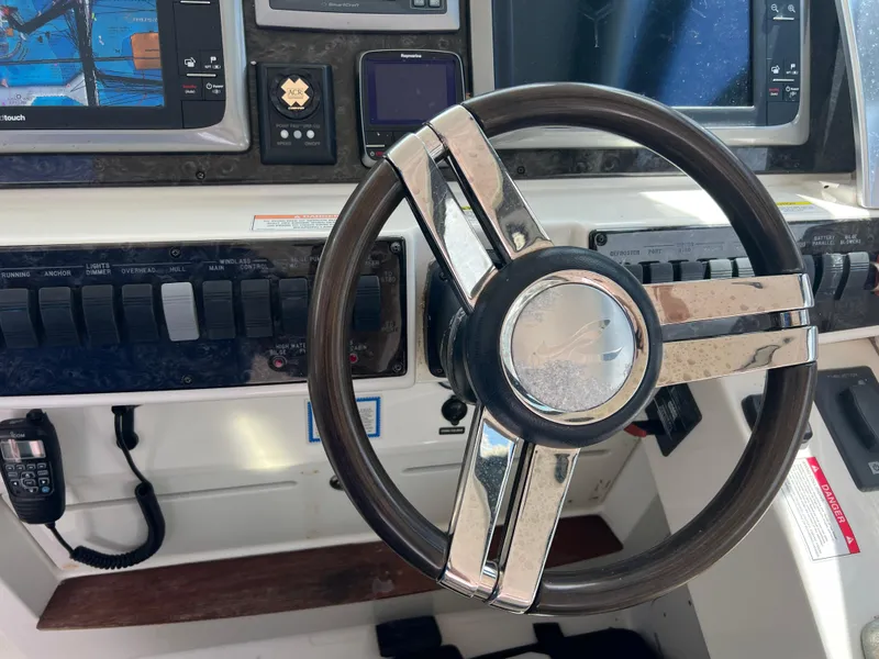 Slide: The Image of Steering wheel and controls of a 2013 Sea Ray 410 Sundancer yacht cockpit. - 36