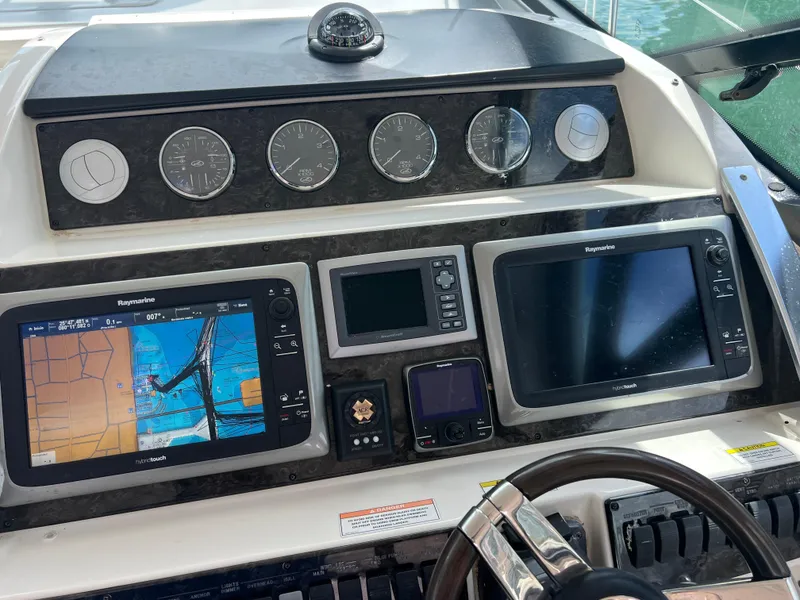 Slide: The Image of Helm of 2013 Sea Ray 410 Sundancer with navigation displays and gauges. - 37