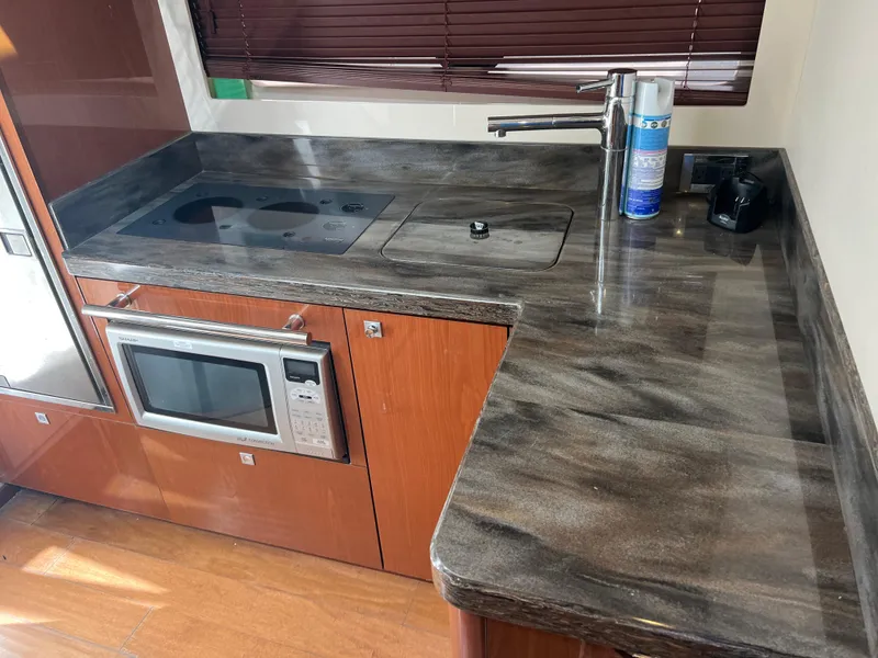 Slide: The Image of Modern kitchen area in a 2013 Sea Ray 410 Sundancer yacht. - 38