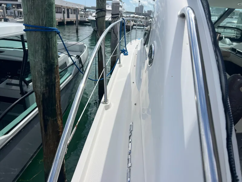 Slide: The Image of 2013 Sea Ray 410 Sundancer yacht docked at marina, side view with railing. - 39