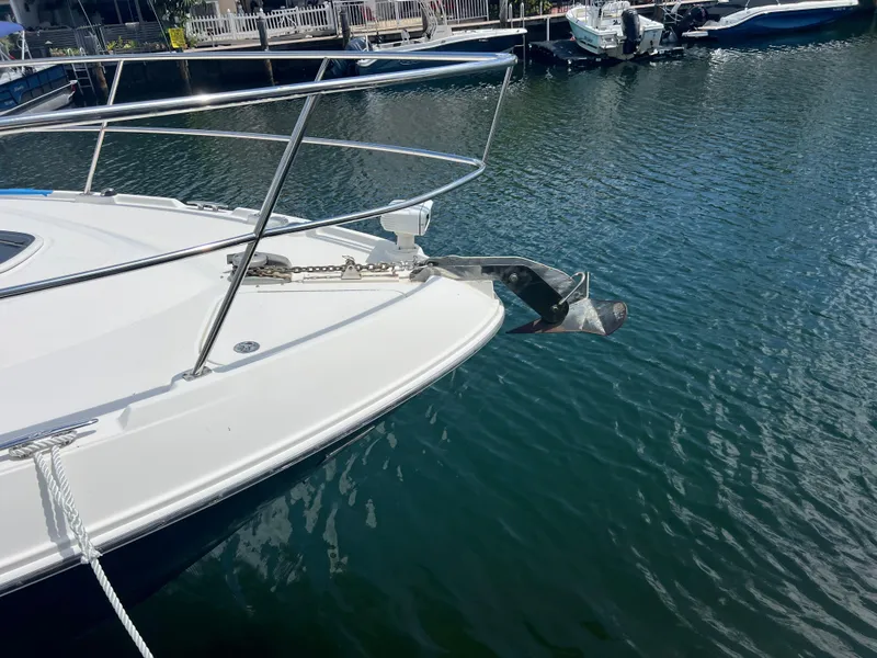 Slide: The Image of Bow of 2013 Sea Ray 410 Sundancer with anchor, docked in calm water. - 4