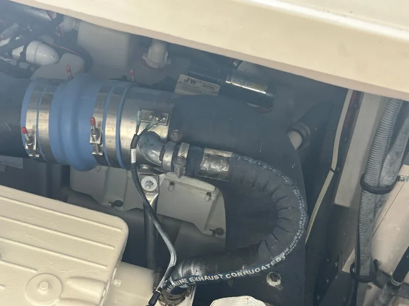 Slide: The Image of Engine compartment of 2013 Sea Ray 410 Sundancer with visible hoses and clamps. - 43