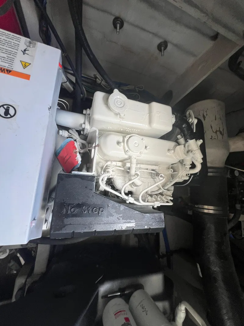 Slide: The Image of Engine compartment of a 2013 Sea Ray 410 Sundancer boat, showcasing mechanical components. - 45