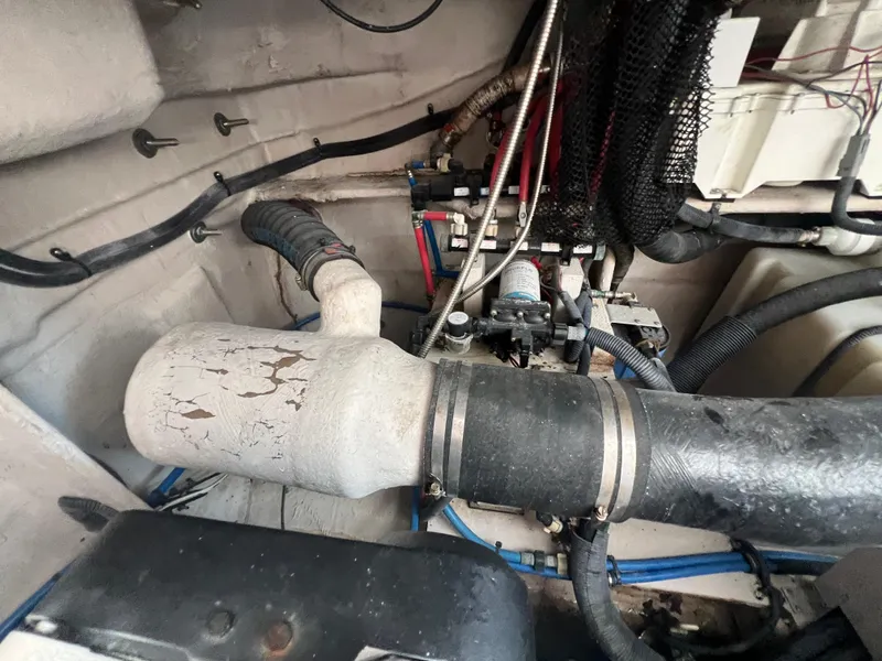 Slide: The Image of Engine compartment of 2013 Sea Ray 410 Sundancer with visible hoses and components. - 46