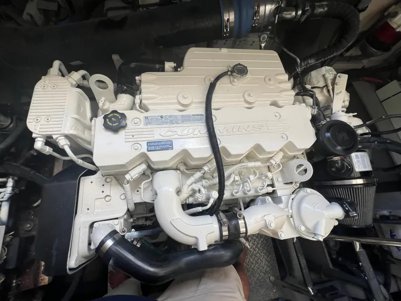 Slide: The Image of Engine of a 2013 Sea Ray 410 Sundancer boat, featuring Cummins components. - 49