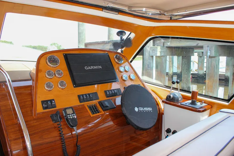 Slide: The Image of 2008 Hinckley Talaria 38R Convertible dashboard with Garmin navigation and Gussi Italia steering wheel. - 13