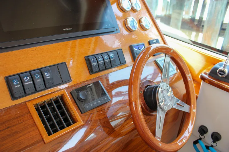 Slide: The Image of Helm of 2008 Hinckley Talaria 38R Convertible with wooden steering wheel and control panel. - 17