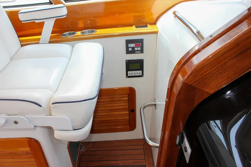 Slide: The Image of 2008 Hinckley Talaria 38R Convertible interior with white seating and wooden accents. - 19