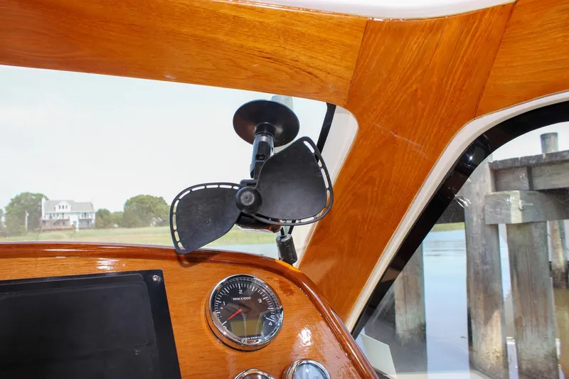 Slide: The Image of Interior of 2008 Hinckley Talaria 38R Convertible with wooden dashboard and fan. - 24