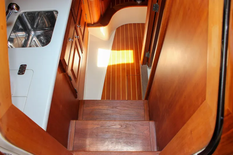 Slide: The Image of Interior of 2008 Hinckley Talaria 38R Convertible, featuring wooden stairs and cabinetry. - 27