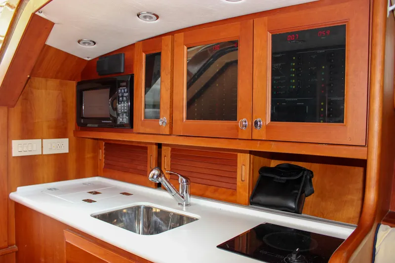 Slide: The Image of Interior of 2008 Hinckley Talaria 38R Convertible yacht kitchen with sink and microwave. - 28