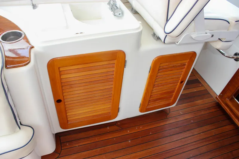 Slide: The Image of 2008 Hinckley Talaria 38R Convertible interior with wooden cabinets and seating. - 8