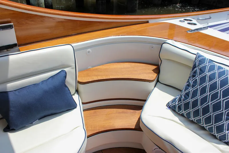 Slide: The Image of Luxury seating area on 2008 Hinckley Talaria 38R Convertible with elegant cushions and wood accents. - 11