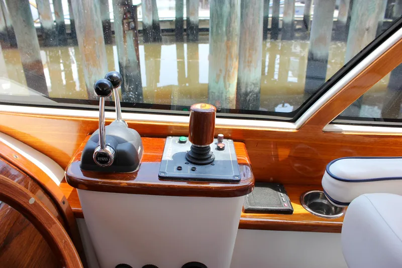 Slide: The Image of Control panel of a 2008 Hinckley Talaria 38R Convertible yacht with wooden accents. - 16