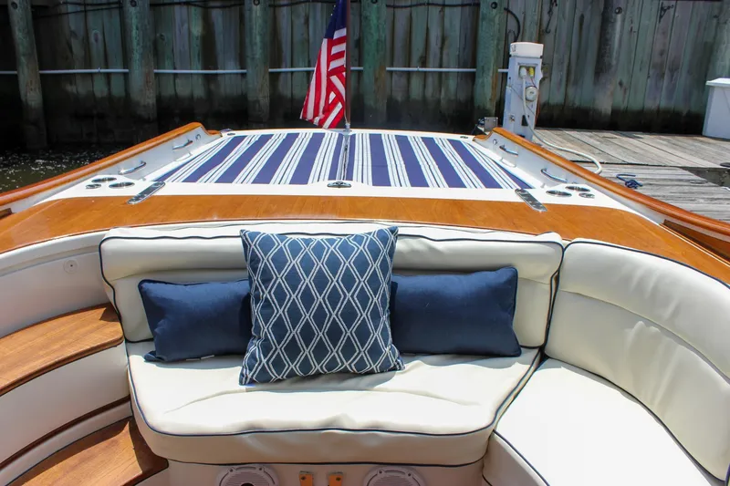 Slide: The Image of Luxury seating on 2008 Hinckley Talaria 38R Convertible yacht with striped cushions and American flag. - 23