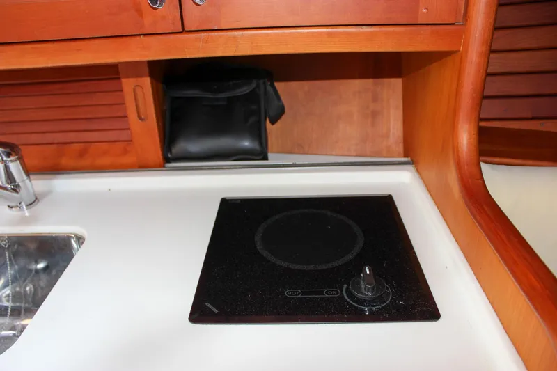 Slide: The Image of Hinckley Talaria 38R Convertible 2008 yacht interior with stove and sink. - 30