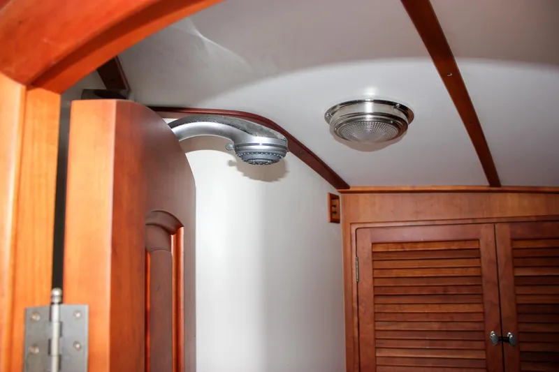 Slide: The Image of Interior of 2008 Hinckley Talaria 38R Convertible, featuring wooden cabinetry and ceiling light. - 35