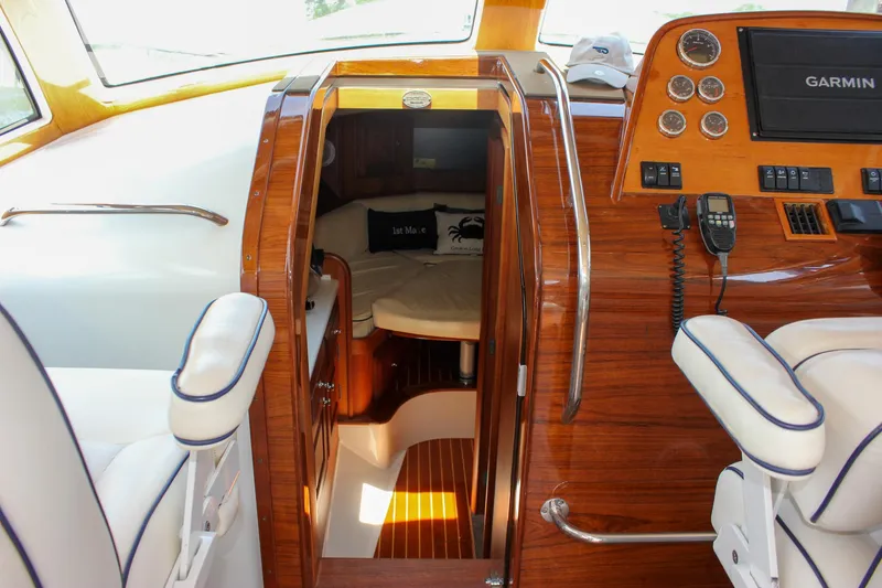 Slide: The Image of Interior of 2008 Hinckley Talaria 38R Convertible with wood finish and navigation equipment. - 40