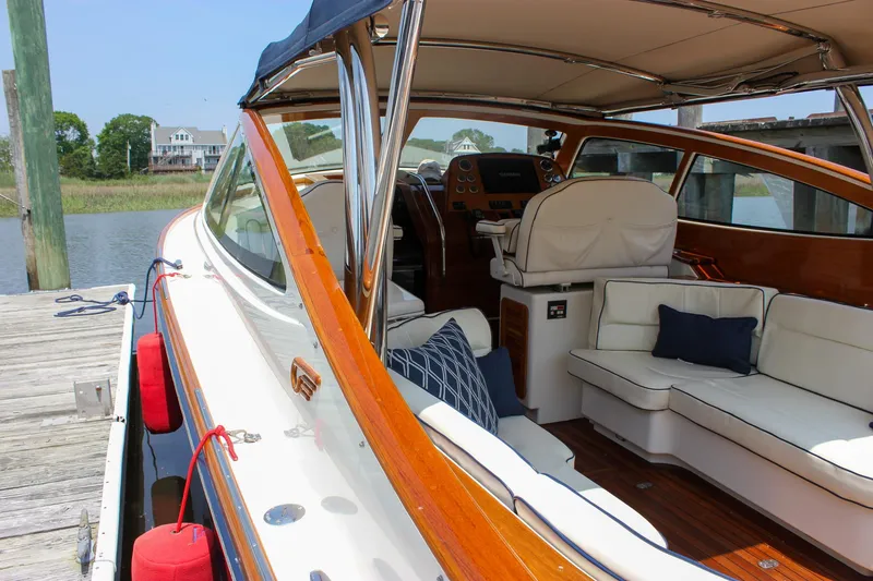 Slide: The Image of 2008 Hinckley Talaria 38R Convertible yacht interior with white seating and wooden accents. - 48