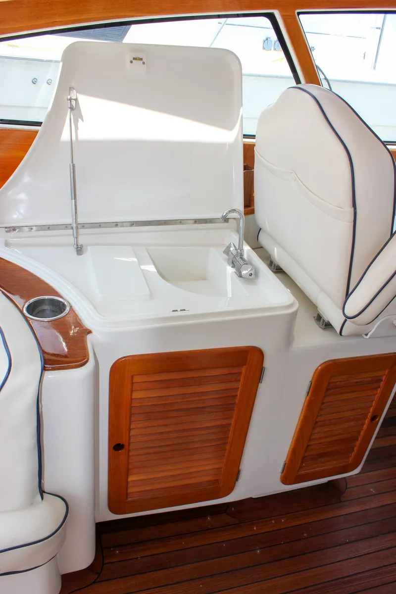 Slide: The Image of 2008 Hinckley Talaria 38R Convertible yacht interior with sink and wooden cabinetry. - 9