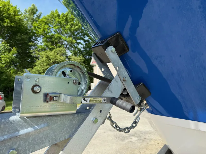 Slide: The Image of Trailer winch attached to a 2008 Pro-Line 29 Grand Sport boat, with lush greenery in the background. - 12