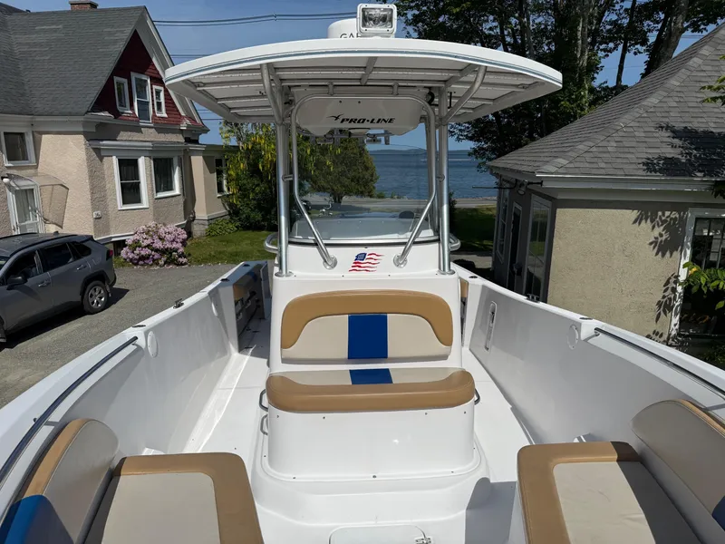 Slide: The Image of 2008 Pro-Line 29 Grand Sport boat with seating, parked near waterfront homes. - 13