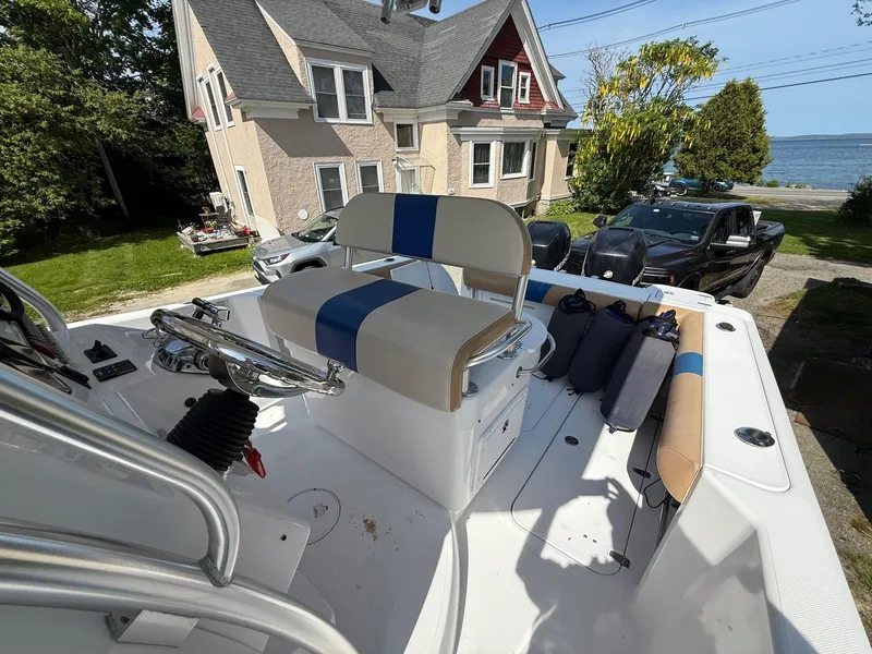 Slide: The Image of 2008 Pro-Line 29 Grand Sport boat with seating, parked near a house by the water. - 16