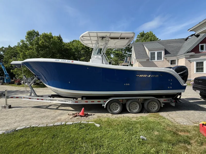 Slide: The Image of 2008 Pro-Line 29 Grand Sport boat on trailer, parked in residential driveway. - 2