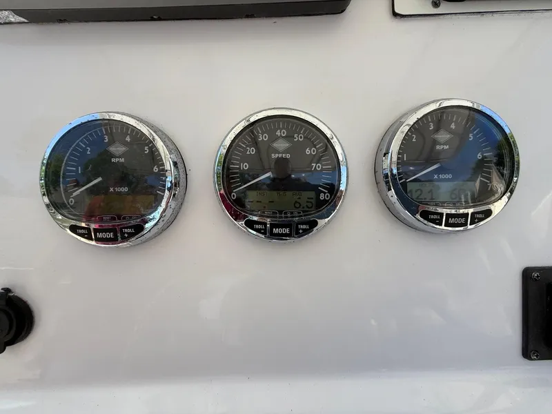 Slide: The Image of Dashboard gauges of a 2008 Pro-Line 29 Grand Sport boat, displaying RPM and speed. - 21
